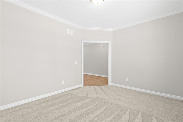 carpeted empty room with crown molding