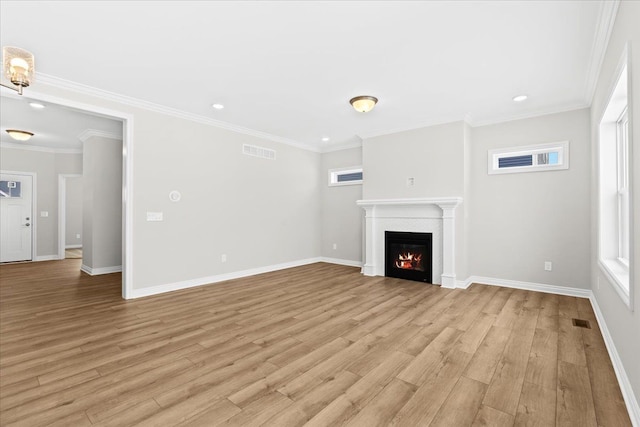 unfurnished living room featuring crown molding and light hardwood / wood-style flooring