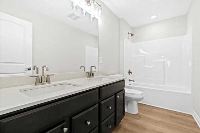 full bathroom featuring shower / tub combination, vanity, toilet, and hardwood / wood-style floors