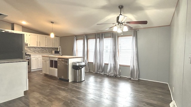 kitchen with decorative light fixtures, tasteful backsplash, lofted ceiling, white cabinets, and stainless steel appliances