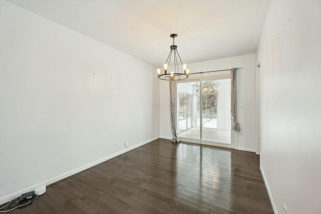 unfurnished dining area featuring dark hardwood / wood-style flooring and a notable chandelier