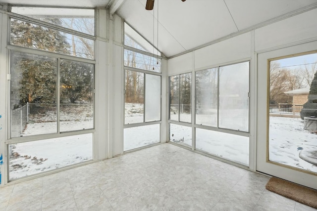 unfurnished sunroom with ceiling fan, plenty of natural light, and vaulted ceiling with beams