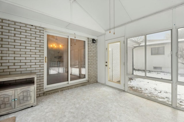 unfurnished sunroom with vaulted ceiling