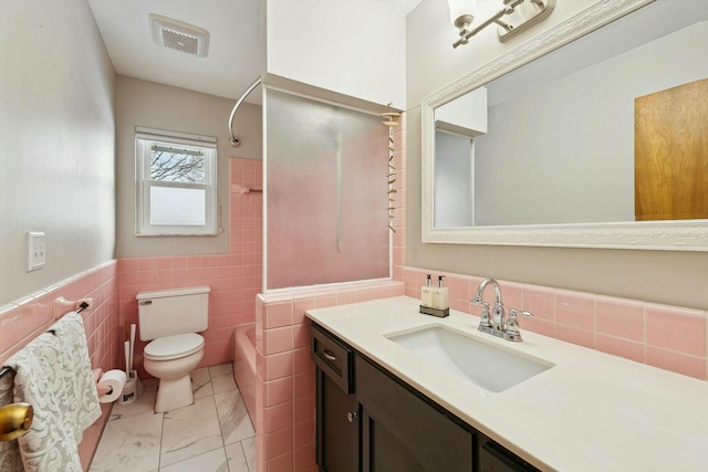 full bathroom with vanity, tub / shower combination, tile walls, and toilet