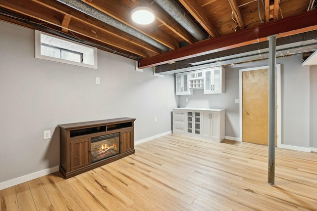 basement with light hardwood / wood-style floors