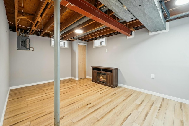 basement with electric panel and hardwood / wood-style floors