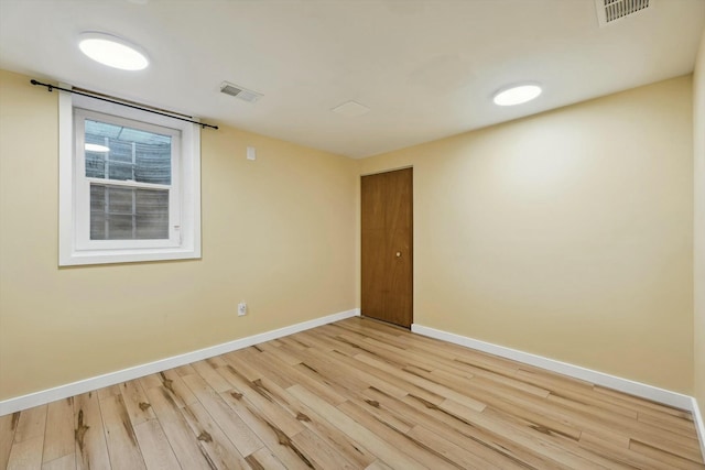 empty room with light hardwood / wood-style floors