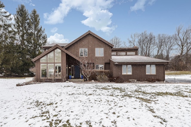 view of snow covered rear of property