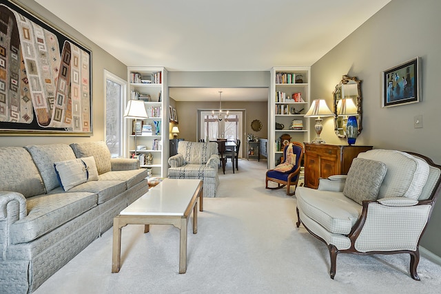 carpeted living room featuring a chandelier