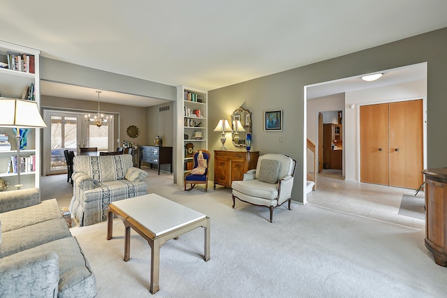 carpeted living room featuring a chandelier