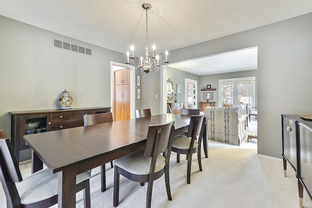 carpeted dining space featuring french doors