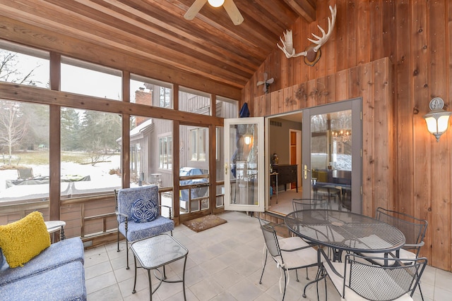 sunroom / solarium with vaulted ceiling, wooden ceiling, and ceiling fan