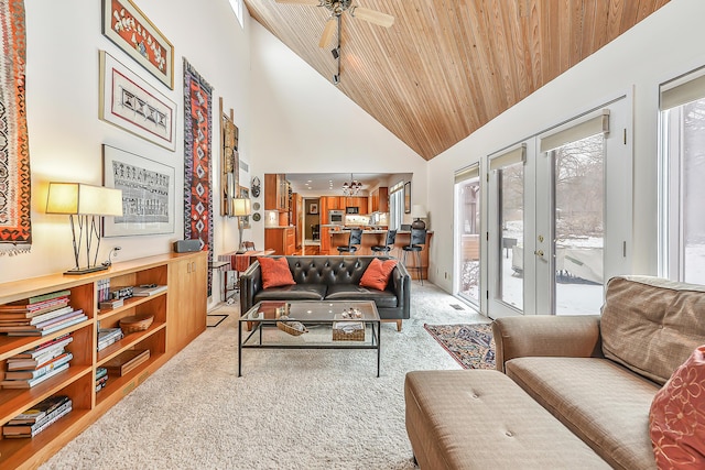 living room with ceiling fan, high vaulted ceiling, carpet floors, wooden ceiling, and french doors