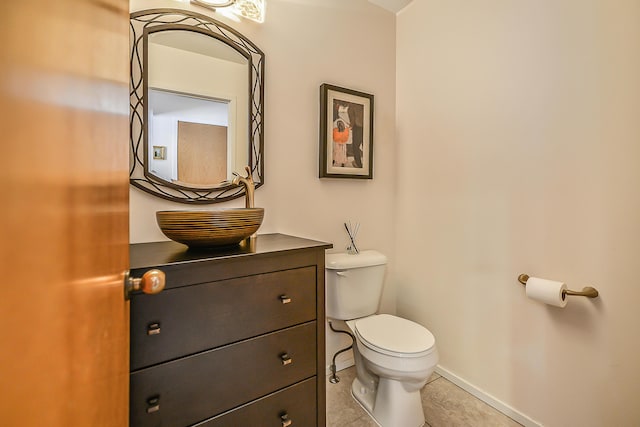 bathroom featuring vanity, tile patterned flooring, and toilet