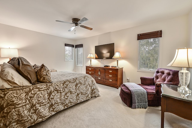 bedroom featuring ceiling fan and light carpet