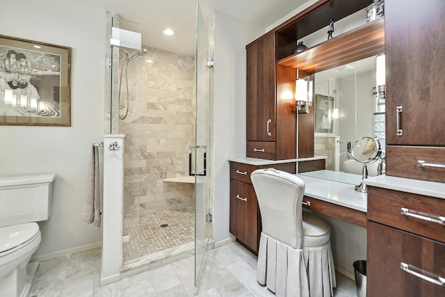 bathroom with vanity, a shower with shower door, and toilet