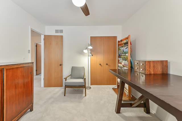 carpeted home office with ceiling fan