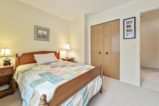 bedroom with light carpet and a closet