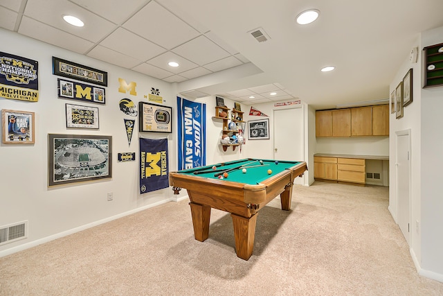 rec room with a paneled ceiling, built in desk, billiards, and light carpet