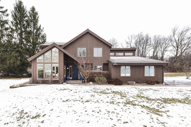 view of snow covered rear of property