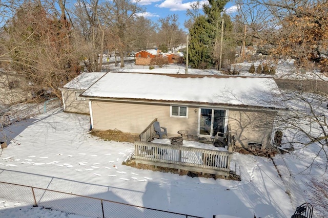 view of snow covered rear of property