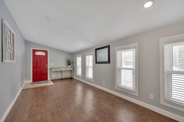 foyer entrance with lofted ceiling and dark hardwood / wood-style floors