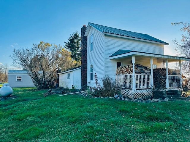 exterior space with a yard and covered porch