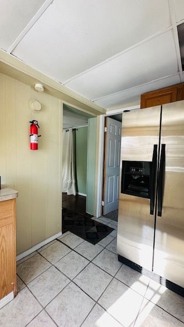 kitchen featuring stainless steel fridge with ice dispenser