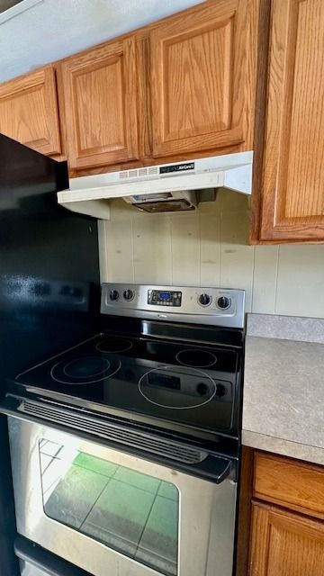 kitchen with stainless steel electric stove and oven