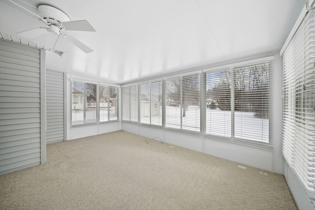 unfurnished sunroom with ceiling fan