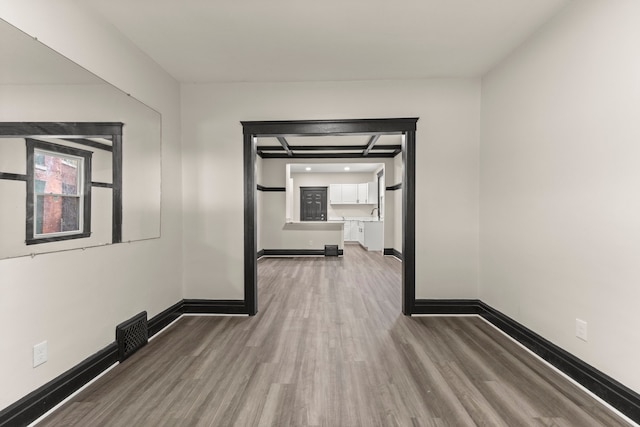 corridor with hardwood / wood-style flooring