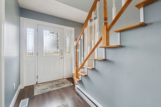 entryway with stairway, baseboards, visible vents, and dark wood-type flooring