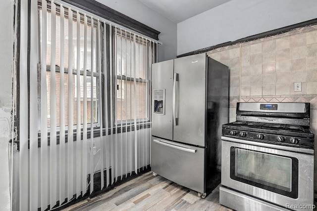 kitchen with light hardwood / wood-style floors and appliances with stainless steel finishes