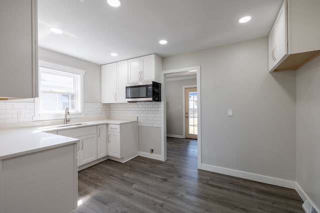 kitchen featuring white cabinetry, sink, decorative backsplash, and dark hardwood / wood-style floors