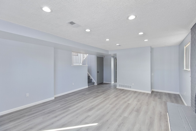 empty room featuring light hardwood / wood-style flooring and a textured ceiling