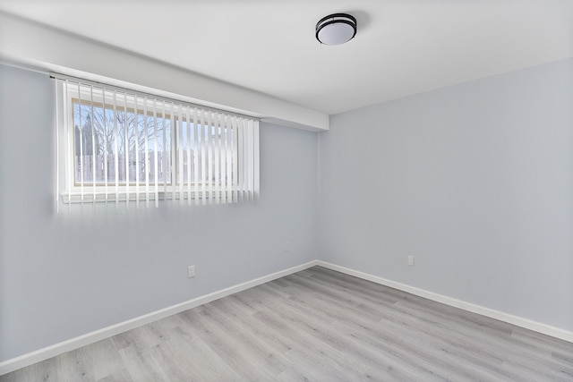 spare room featuring light hardwood / wood-style flooring and a wealth of natural light