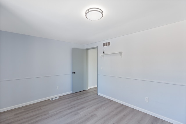 unfurnished room with light hardwood / wood-style flooring