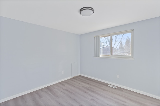 empty room with light hardwood / wood-style flooring