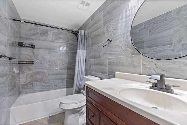 full bathroom with tile walls, vanity, toilet, and shower / bathtub combination with curtain