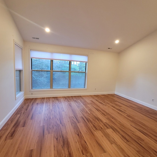 empty room with light hardwood / wood-style floors