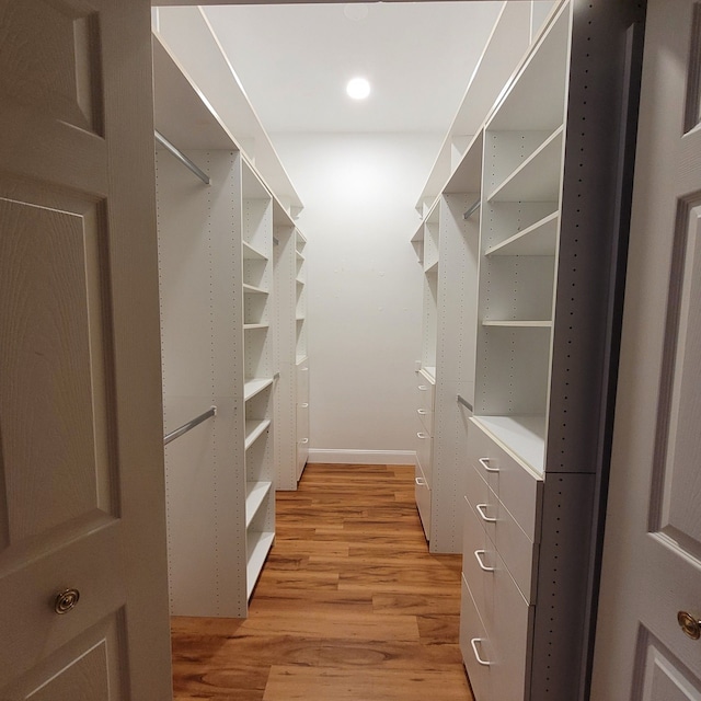 spacious closet with light hardwood / wood-style floors