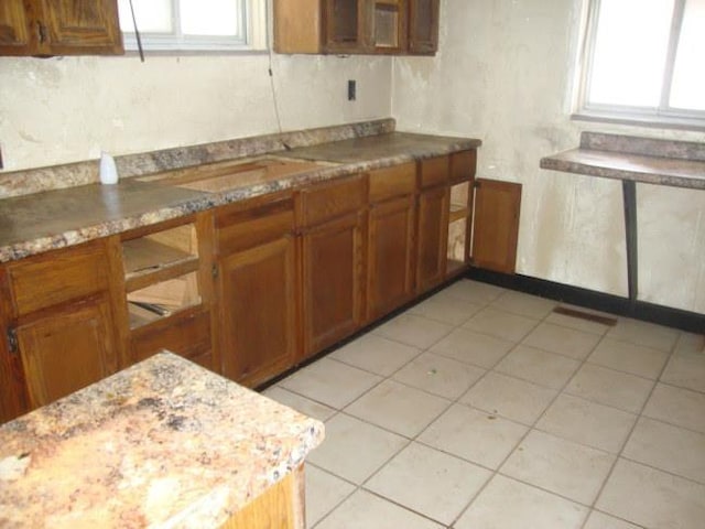 kitchen with light stone countertops and a wealth of natural light