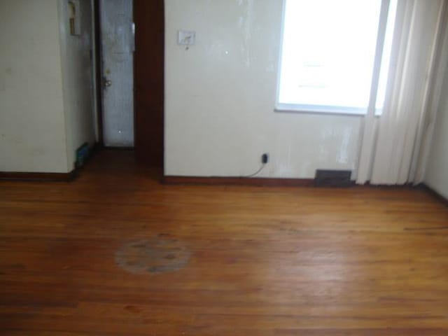 empty room featuring wood-type flooring