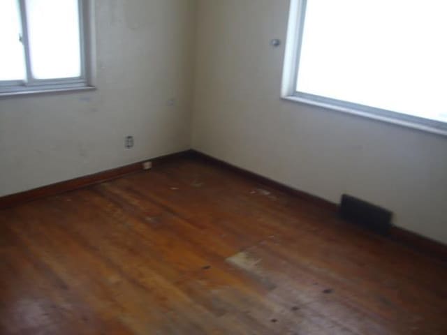 unfurnished room featuring dark hardwood / wood-style floors