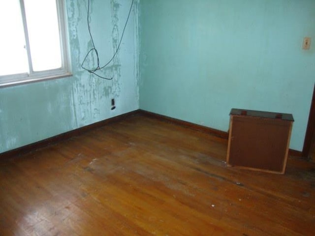 empty room with dark wood-type flooring