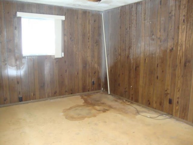 spare room with wooden walls