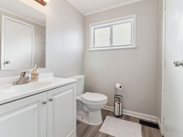 bathroom with vanity, wood-type flooring, and toilet