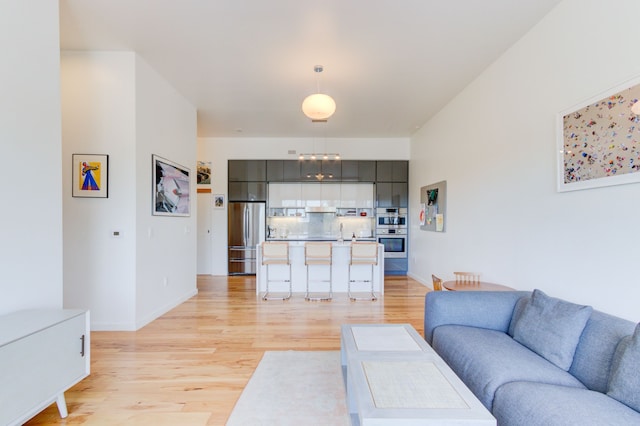 living room featuring sink and light wood-type flooring