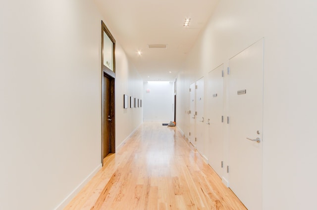 hall with light hardwood / wood-style floors