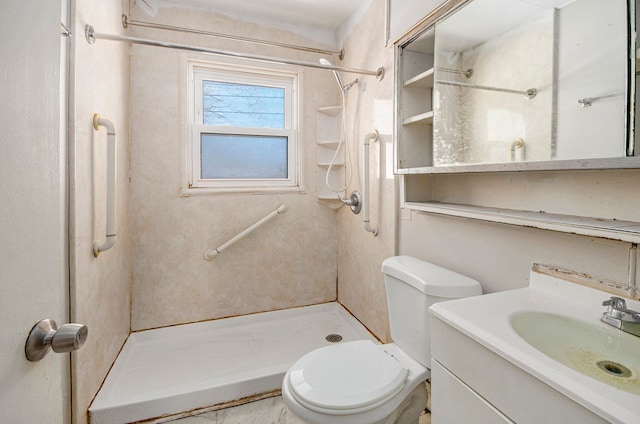 bathroom featuring vanity, toilet, and a shower